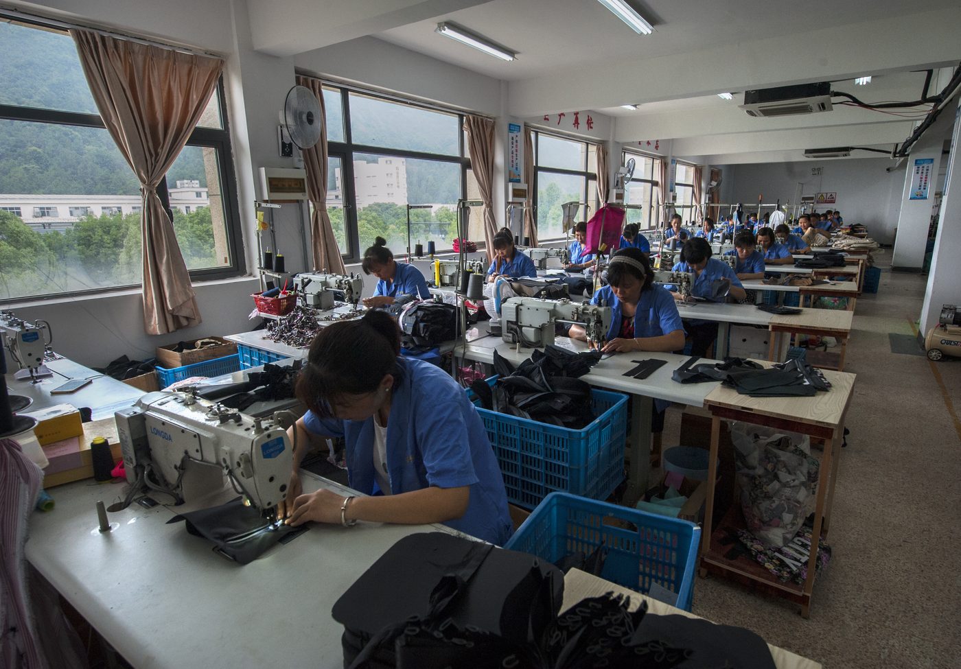 Workers at sewing machines on the production floor